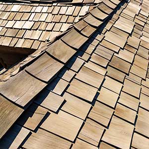 Close up of a residential composite roof that looks like cedar shake