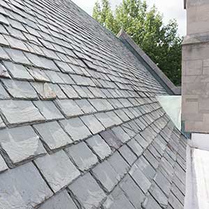 Close up of a residential roof with gray slate tiles